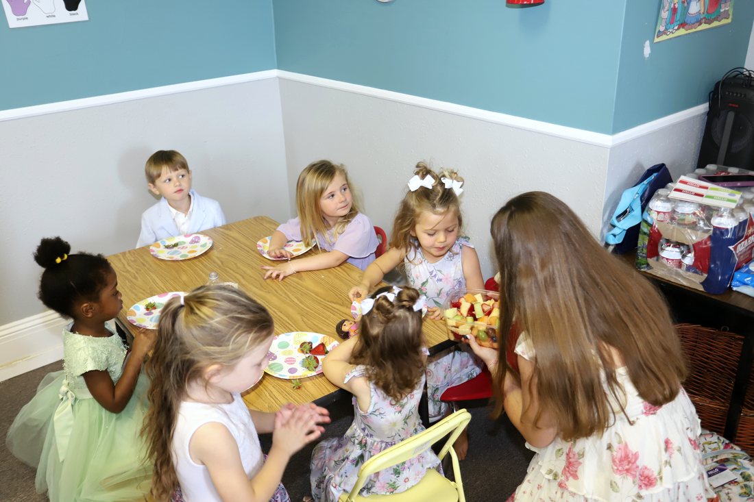 Children in the nursery gathered around the table